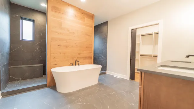 a view of an empty room with wooden floor and windows