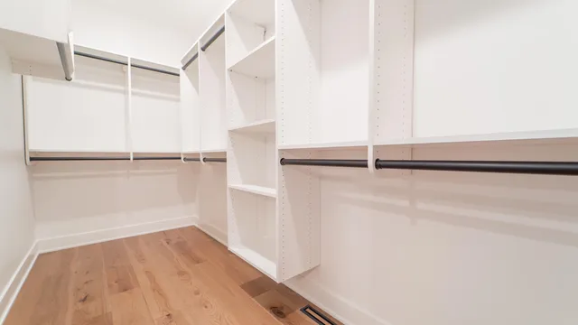 a kitchen with stainless steel appliances a refrigerator and a wooden floor