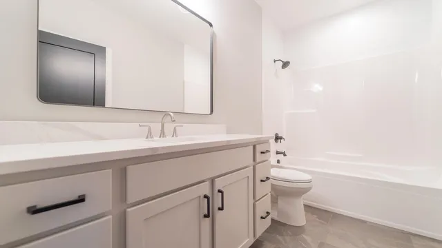 a front view of a house with a garden and yard