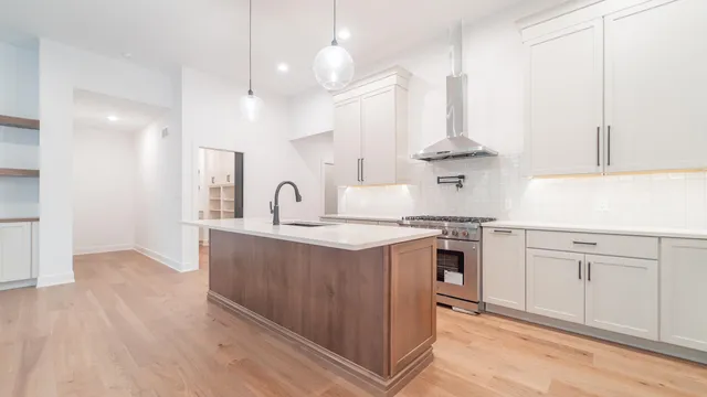 a view of a kitchen with a sink and a window