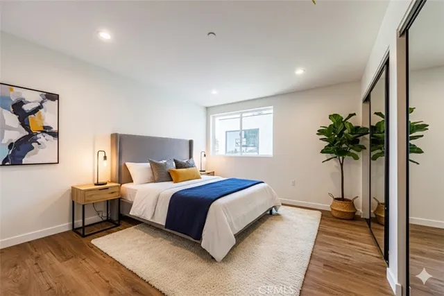 a bed room with a bed window and a potted plant