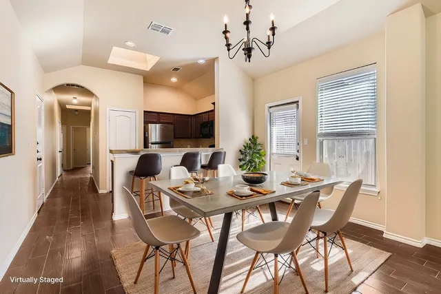 a view of a dining room with furniture and wooden floor