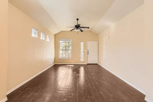 wooden floor in an empty room with a window