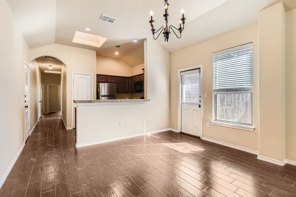 a view of a kitchen with a microwave and a flat screen tv