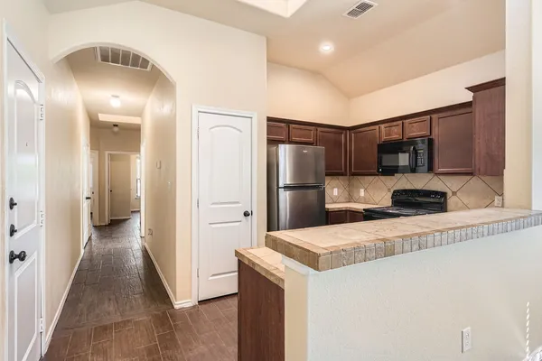 a kitchen with stainless steel appliances a refrigerator and a sink