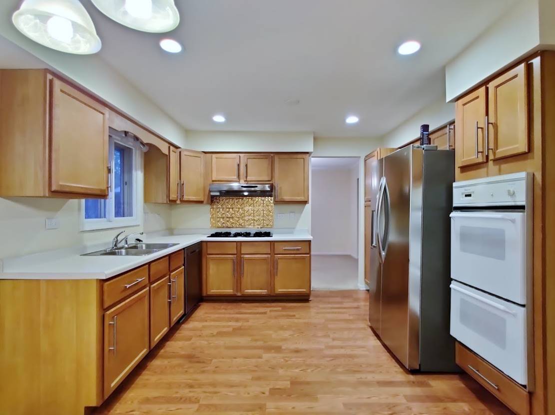 1520 Chippewa Drive Naperville, IL 60563 - Photo 5 of 18 a kitchen with stainless steel appliances granite countertop a refrigerator a sink dishwasher a stove with wooden cabinets and floor