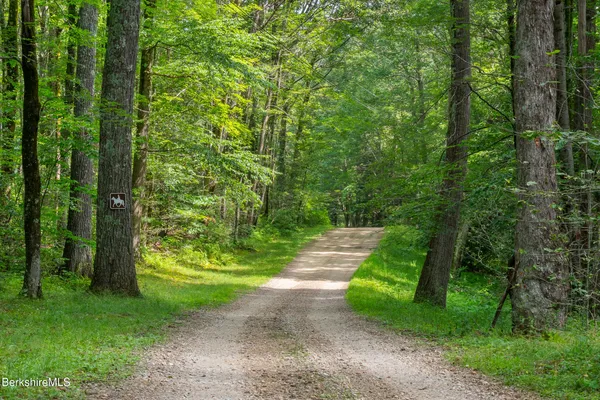 a view of a house with swimming pool and a yard