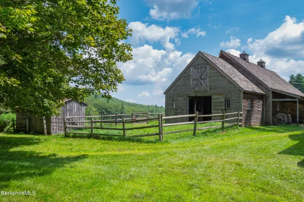 a view of a patio with table and chairs potted plants with wooden floor and fence