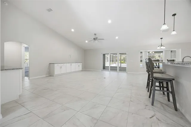 a kitchen with stainless steel appliances granite countertop a refrigerator and a microwave