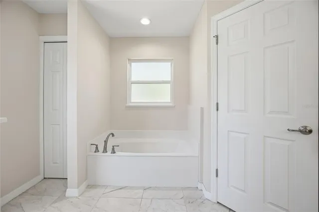 a white bath tub sitting next to a window