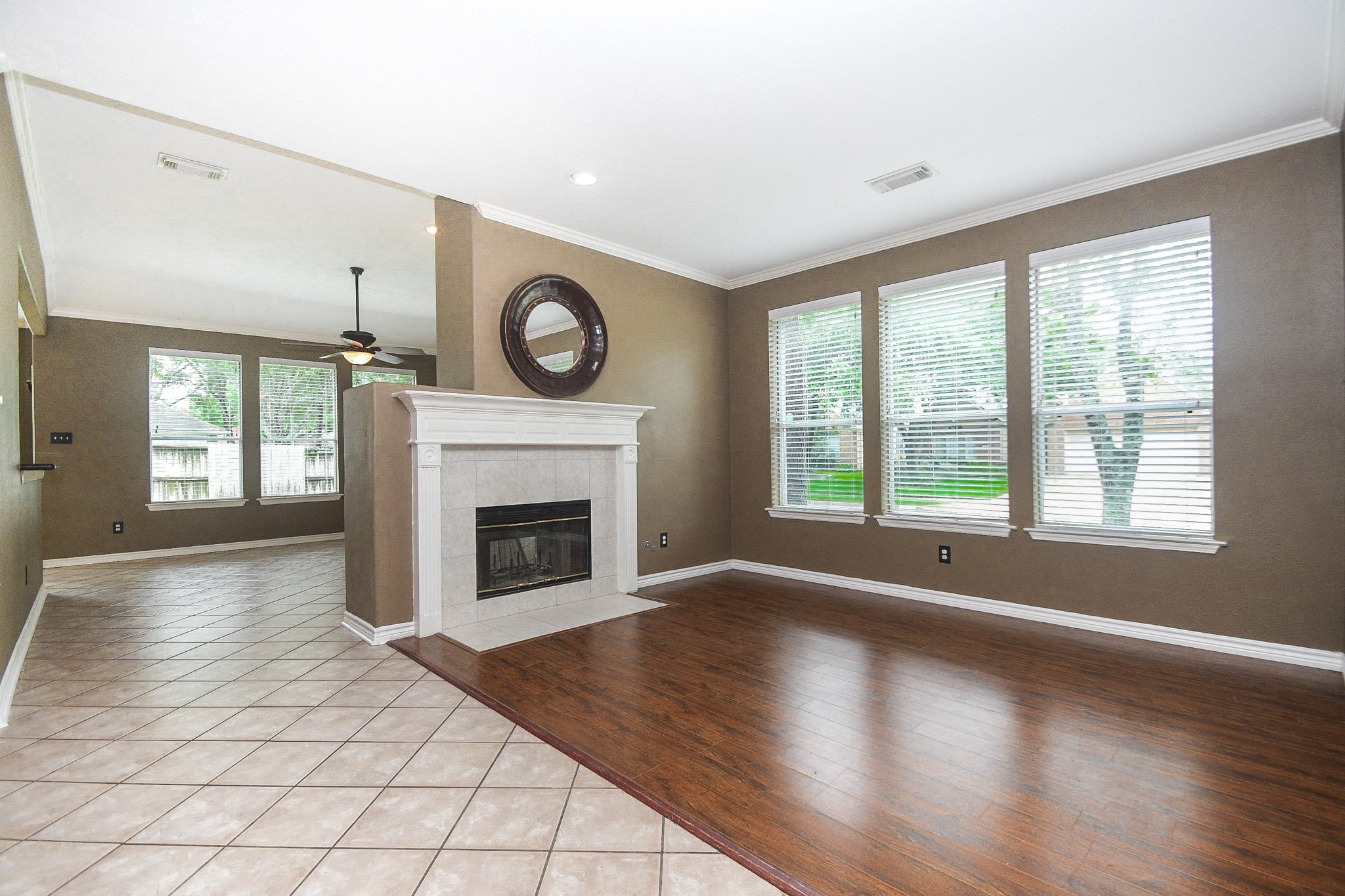5602 Walkabout Way Katy, TX 77450 - Photo 3 of 33 a view of a livingroom with a fireplace wooden floor and windows