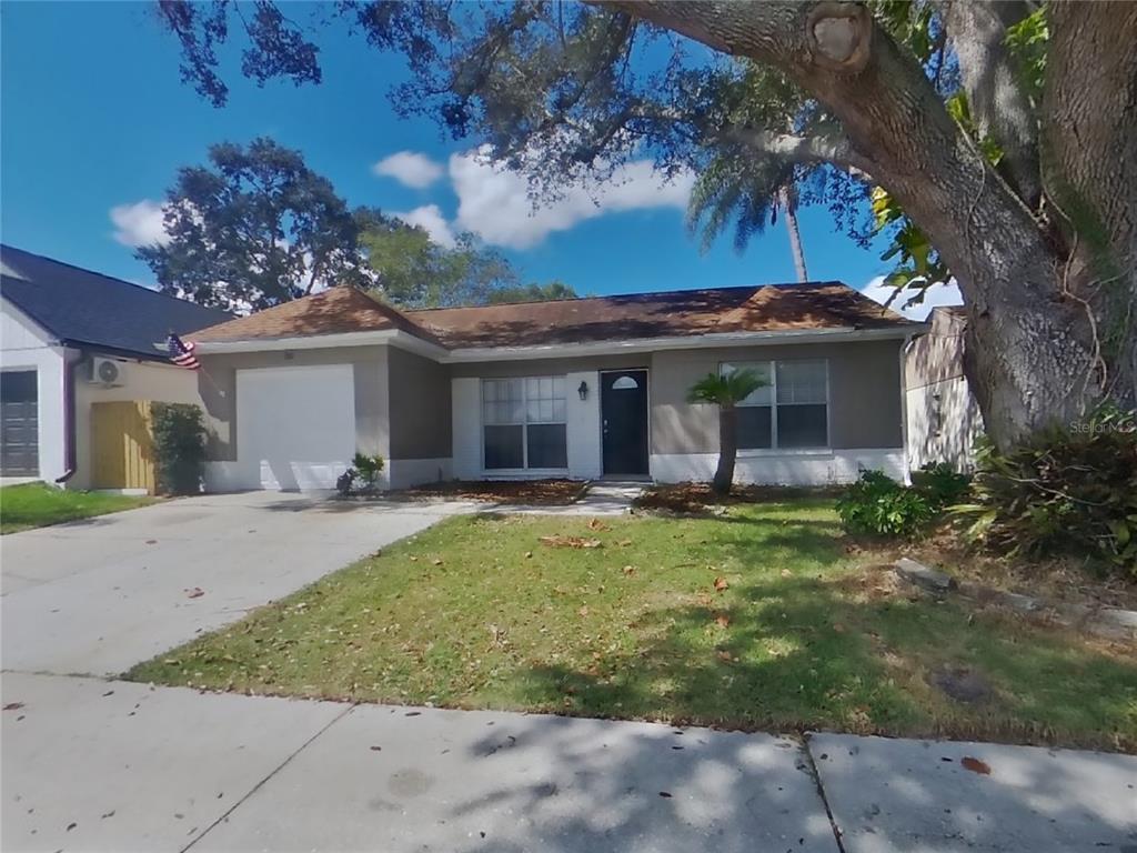 a view of a house with backyard and sitting area
