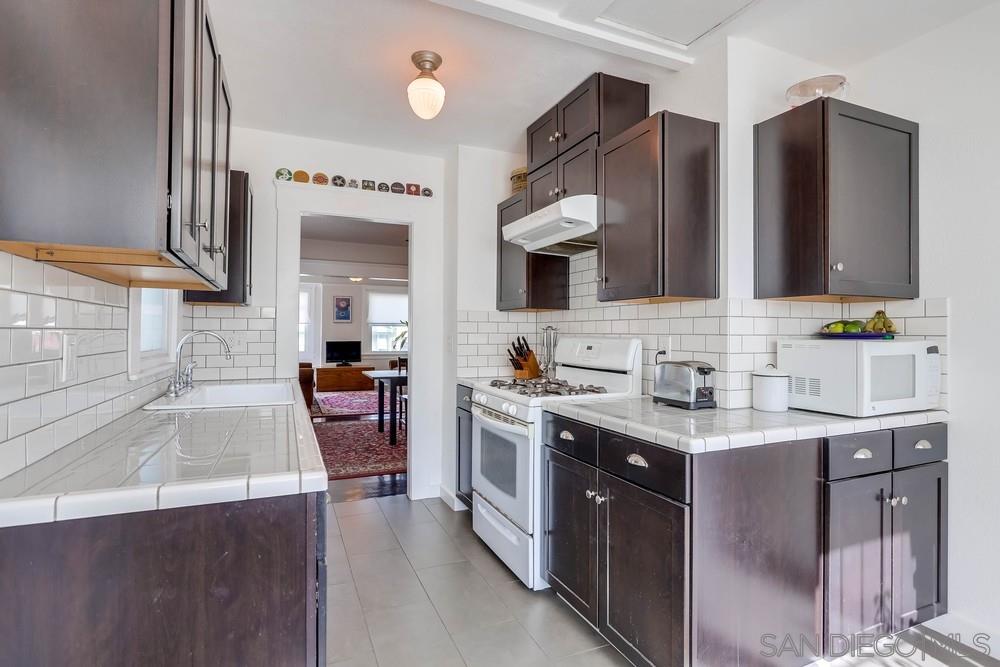2525 E Street San Diego, CA 92102 - Photo 12 of 46 a kitchen with stainless steel appliances a sink stove and cabinets