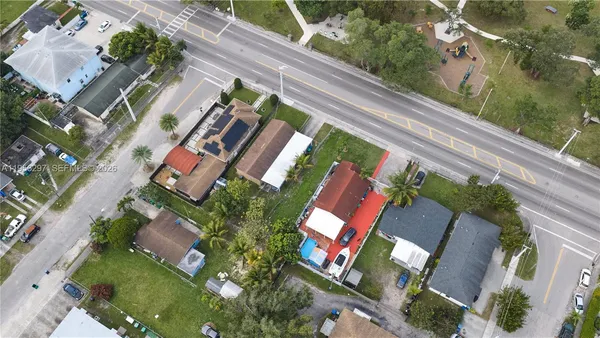 an aerial view of a house with a yard and garden