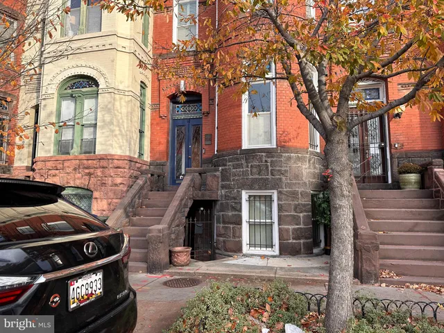 a view of a brick house with many windows