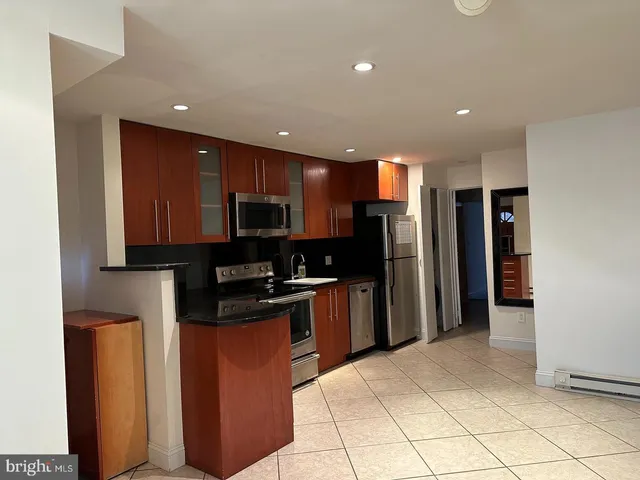 a kitchen with stainless steel appliances granite countertop a refrigerator and a sink