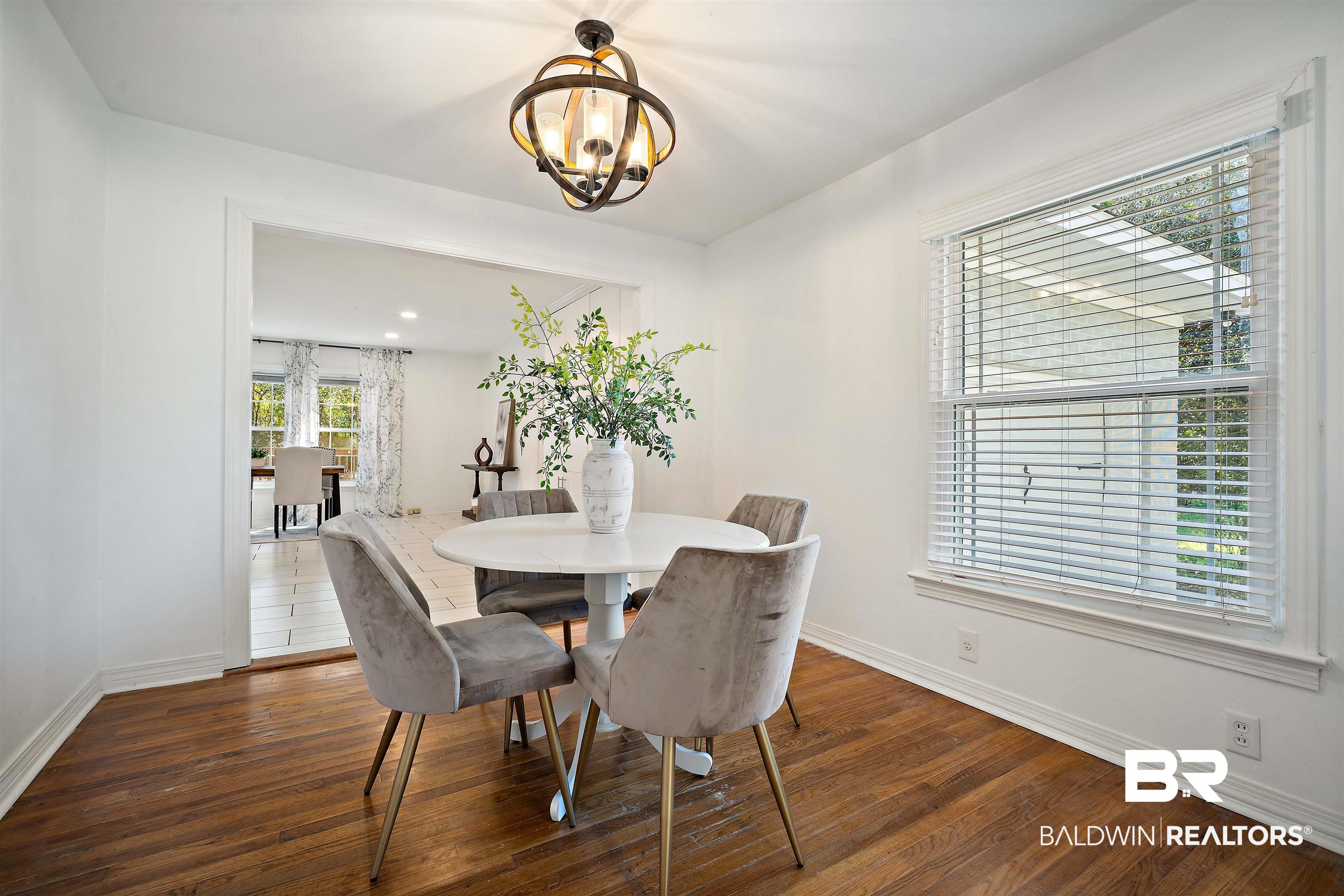 2615 Walton Avenue Mobile, AL 36606 - Photo 17 of 33 Dining area featuring a notable chandelier, baseboards, and wood finished floors