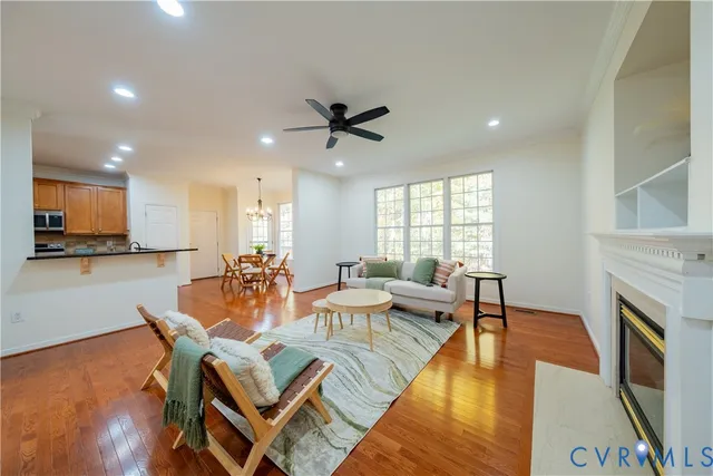 a living room with fireplace furniture and a wooden floor