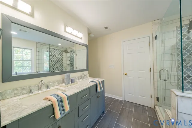 a bathroom with a double vanity sink and a mirror