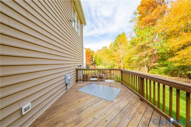 a view of balcony with wooden floor and fence