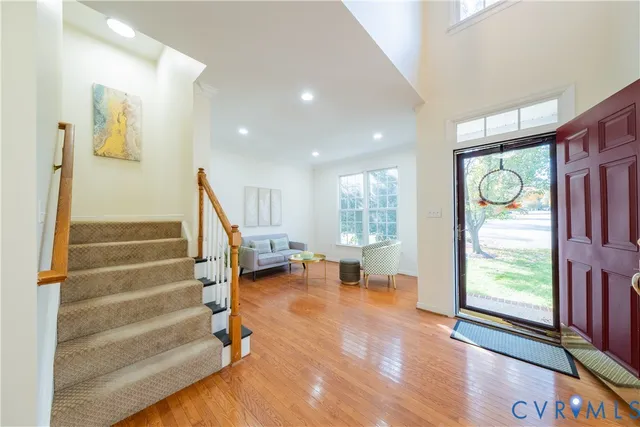 a view of an entryway with wooden floor and windows