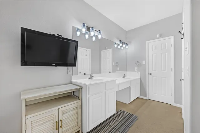 a spacious bathroom with a sink and a mirror