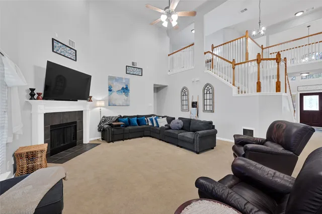 a living room with furniture a flat screen tv and a fireplace