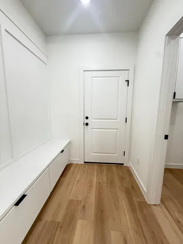 a view of empty room with wooden floor