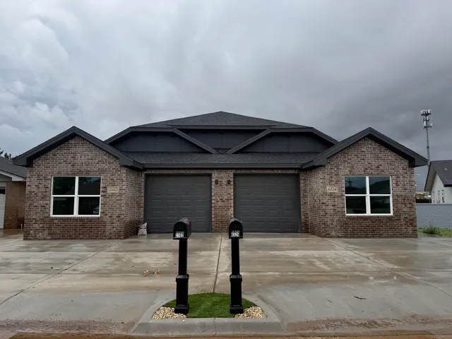 a front view of a house with garage