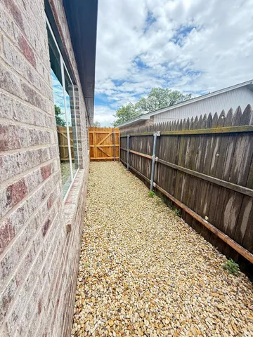 a view of balcony with wooden floor and fence