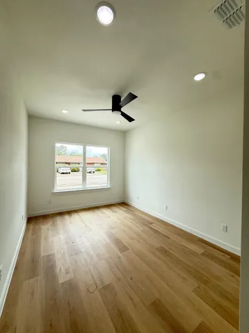 a view of an empty room and wooden floor