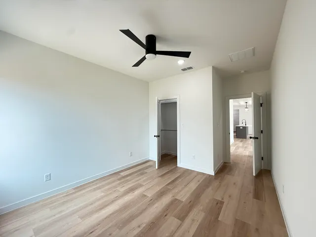 a view of empty room with wooden floor