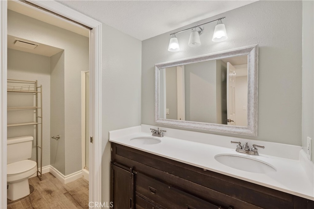 600 Central, Unit 291 Riverside, CA 92507 - Photo 15 of 35 a bathroom with a sink a toilet and a mirror