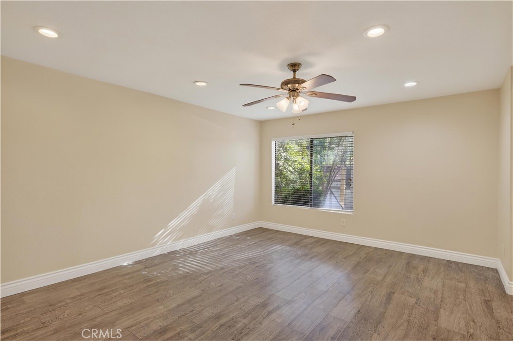 600 Central, Unit 291 Riverside, CA 92507 - Photo 3 of 35 an empty room with wooden floor and windows