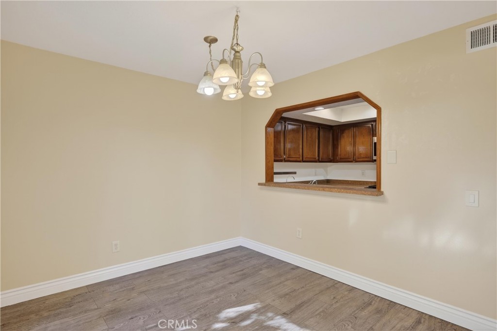 600 Central, Unit 291 Riverside, CA 92507 - Photo 7 of 35 an empty room with wooden floor and windows