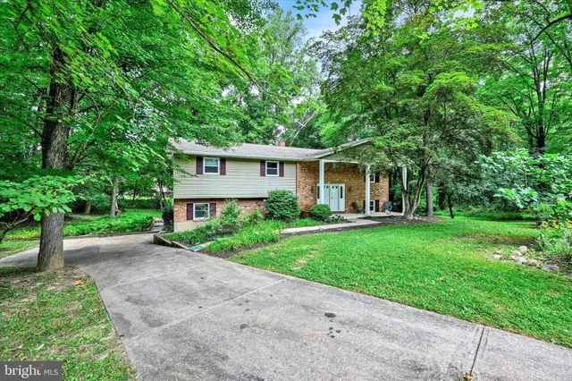 a front view of house with yard and green space