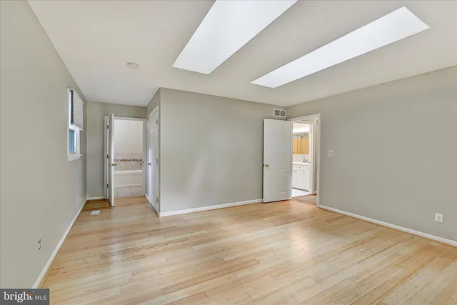 a view of an empty room with wooden floor