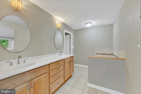 a bathroom with a double vanity sink and a mirror
