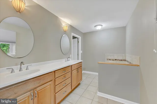 a bathroom with a double vanity sink and a mirror