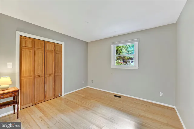 a view of room with window and wooden floor