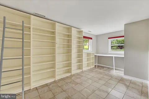 a view of an empty room with empty shelves