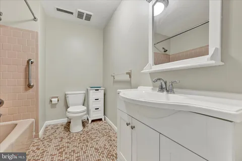a bathroom with a sink toilet a mirror and shower