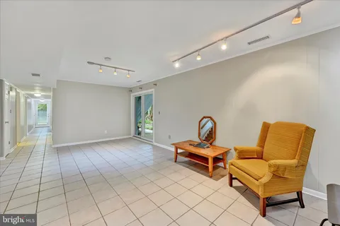 a living room with furniture and a lamp