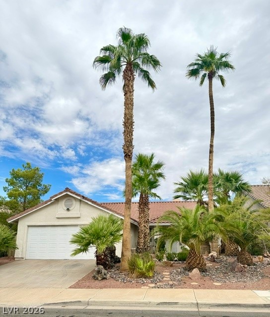 804 Rancho Coast Way Henderson, NV 89002 - Photo 2 of 20 Soaring palm trees frame a classic tiled roofline and attached two-car garage.
