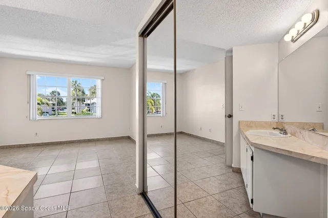 a bathroom with a granite countertop sink a toilet and a mirror