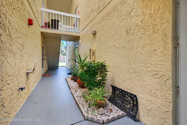 a view of a chairs and table in the balcony