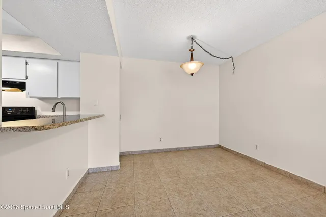 a view of a kitchen with a sink and a window