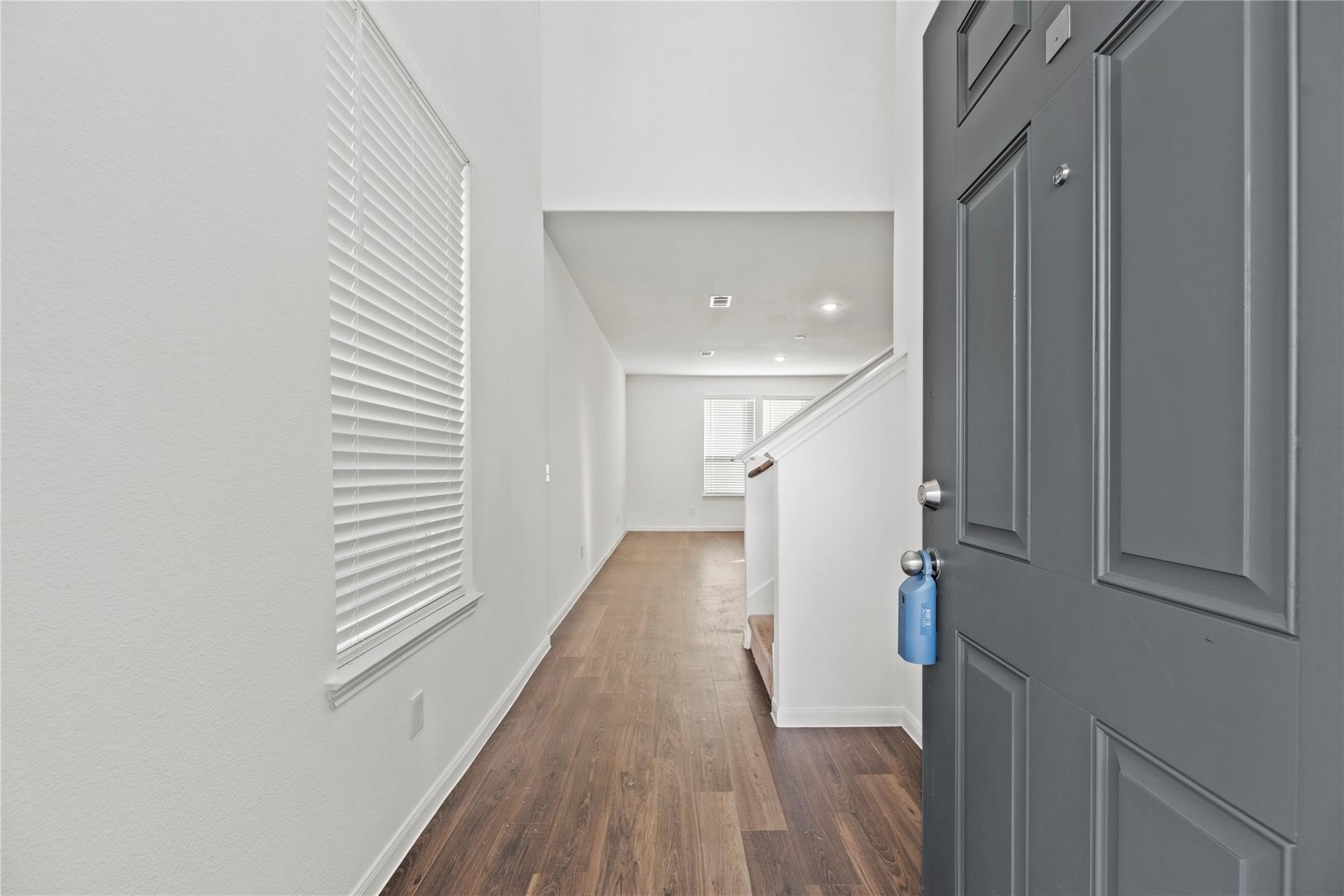 7322 Madison Cmns Lane Houston, TX 77075 - Photo 2 of 14 a view of entryway and hall with wooden floor