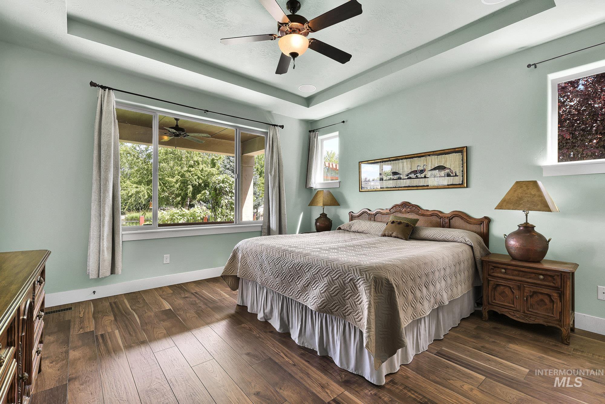 220 South Wildgrass Way Star, ID 83669 - Photo 17 of 50 Dining area featuring a bronze chandelier with frosted glass shades, wood-finish flooring, and light green walls