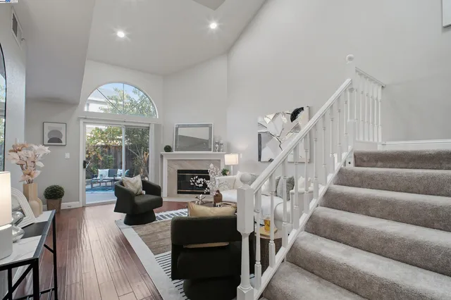 a view of a hallway with wooden floor windows and a livingroom